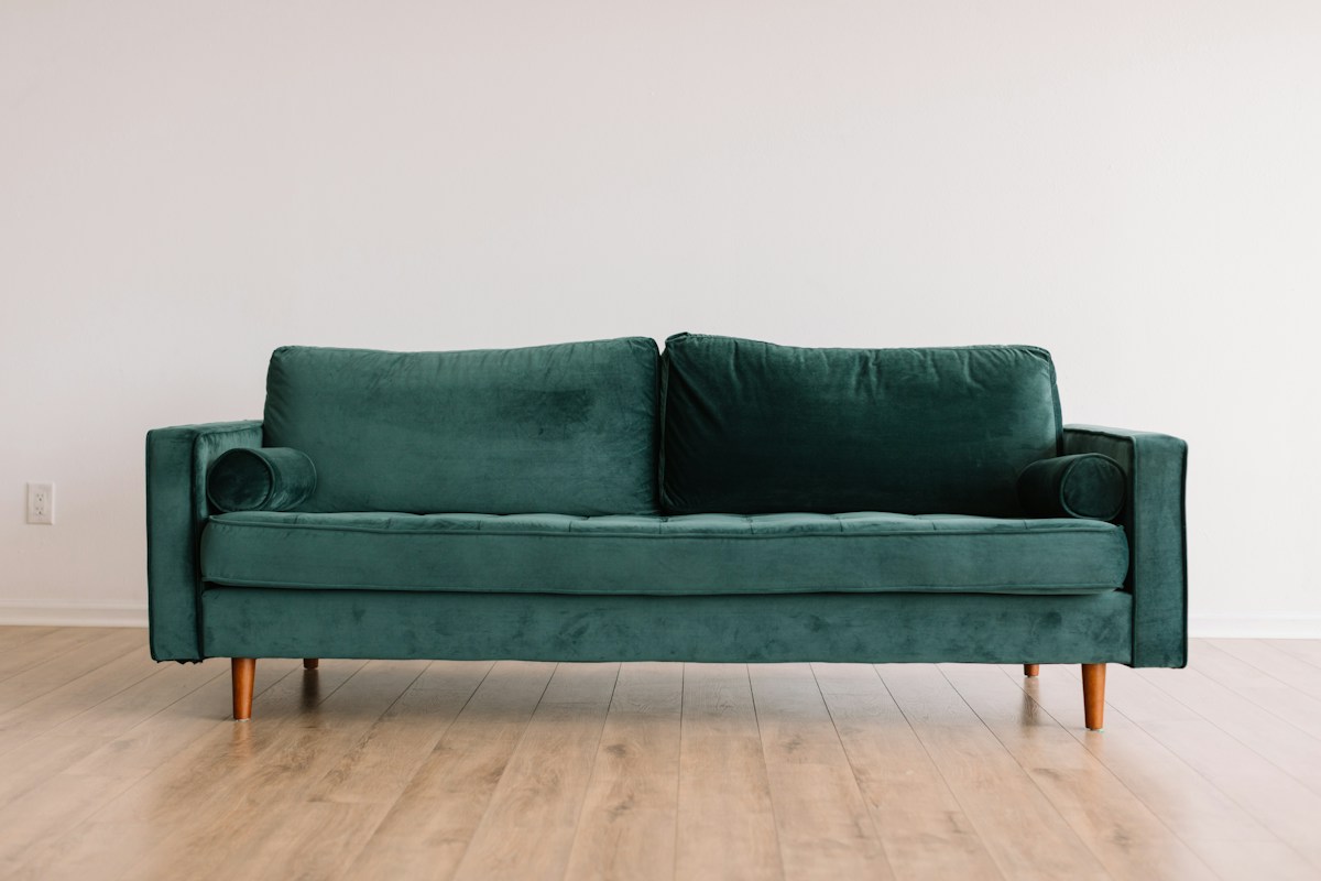 Soft green upholstery with a pale throw